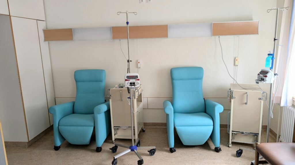 Calm hospital room featuring infusion chairs and equipment for chemotherapy treatment.