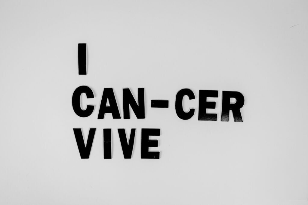 Creative message symbolizing cancer survival with black letters on white background.